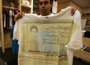 A salesperson shows a T-shirt with a picture of late Colombian cocaine kingpin Pablo Escobar at a store in Zapopan on the outskirts of Guadalajara September 28, 2012.